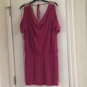 Magenta cold shoulder mini dress with silver detail on shoulder.